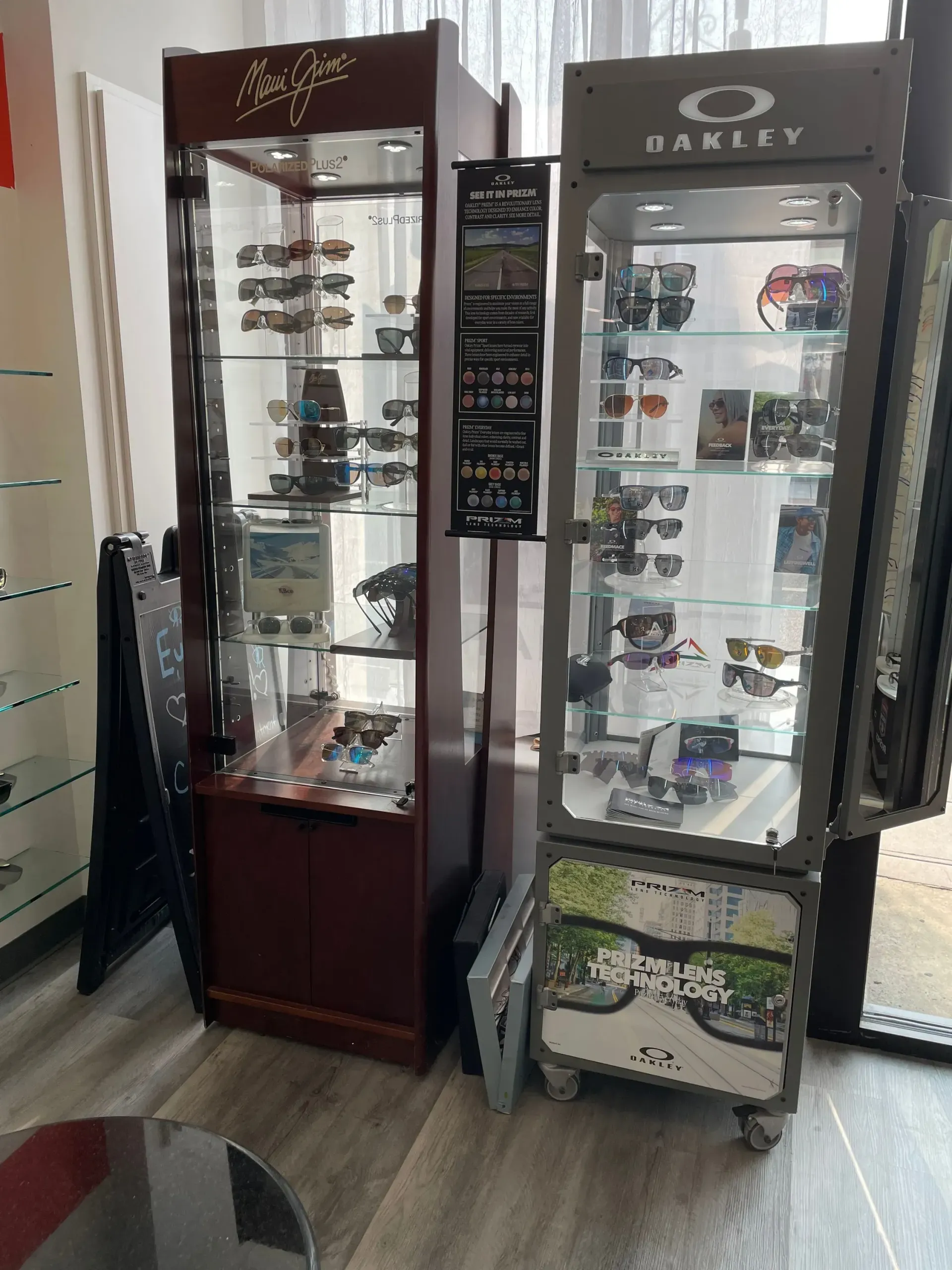 A display case filled with sunglasses and a oakley display case.