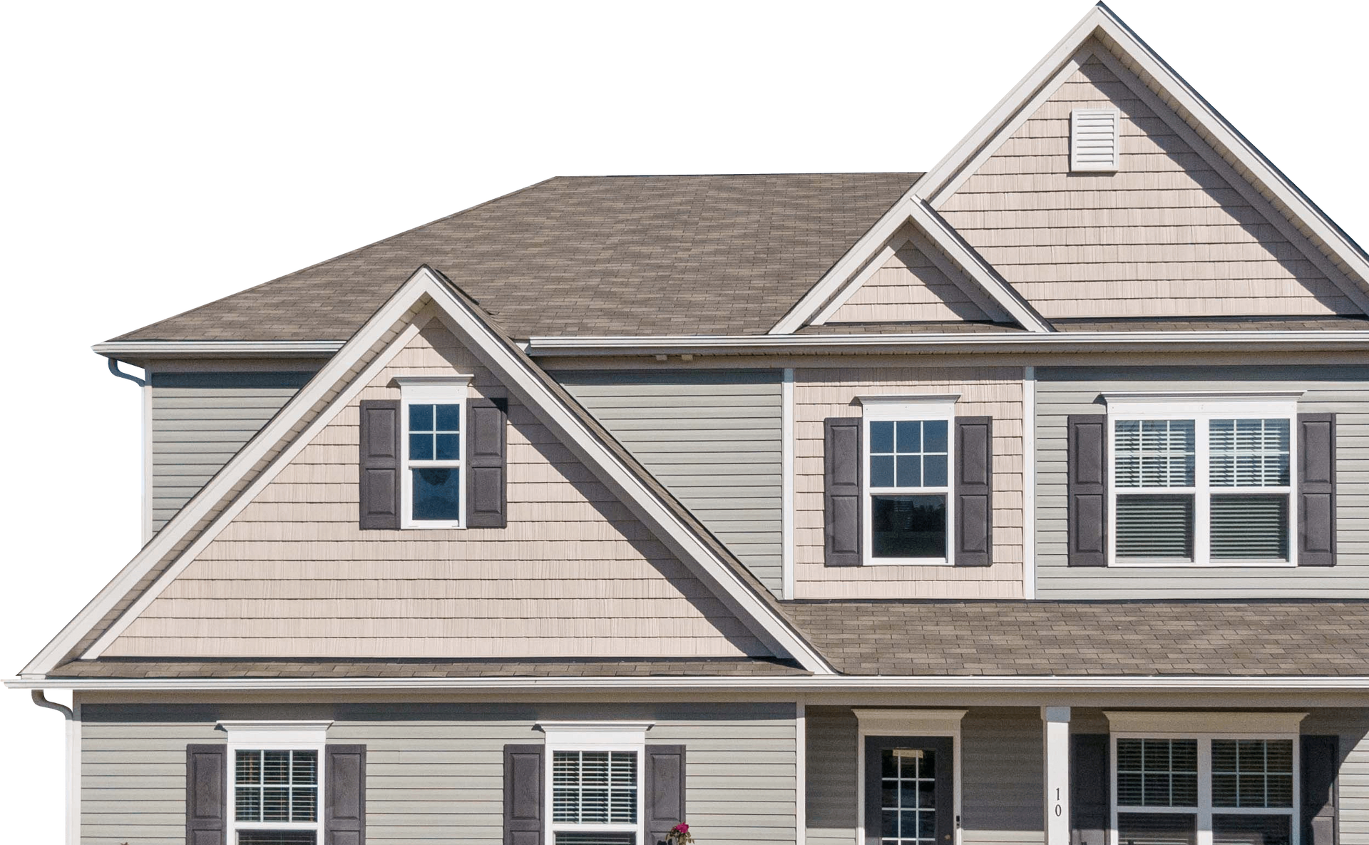 Exterior of a beige suburban house with gray roof and dormer windows