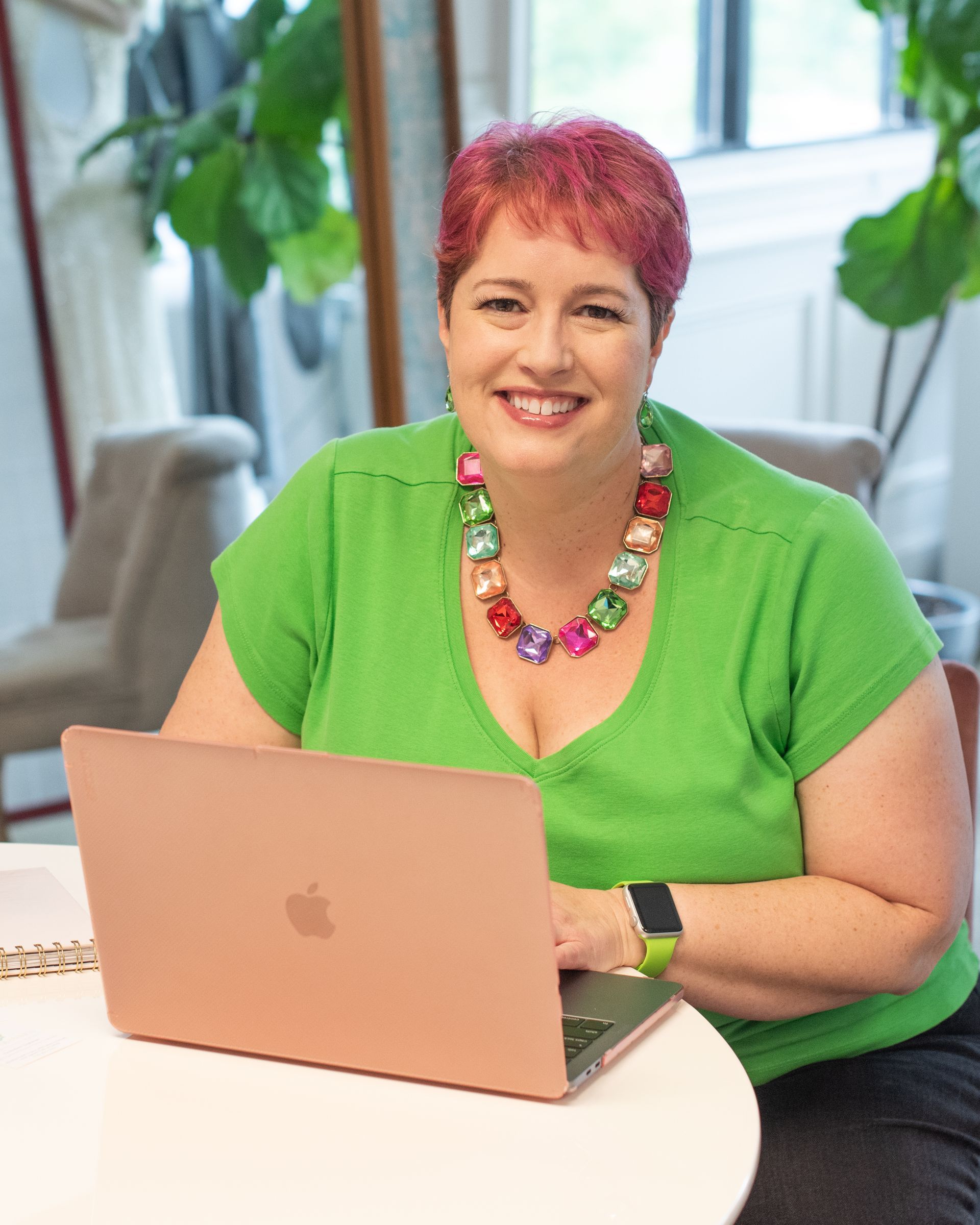 Gretchen Tegtman sitting in front of a laptop smiling