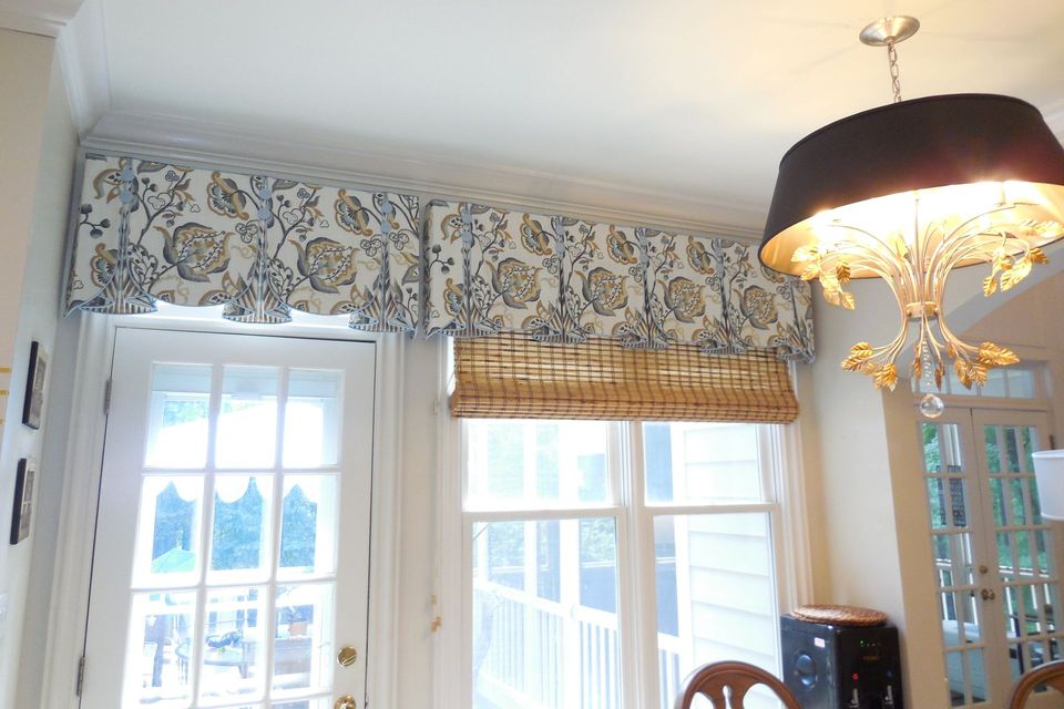 Bright sunlit room with floral valance, French doors, and a hanging lamp