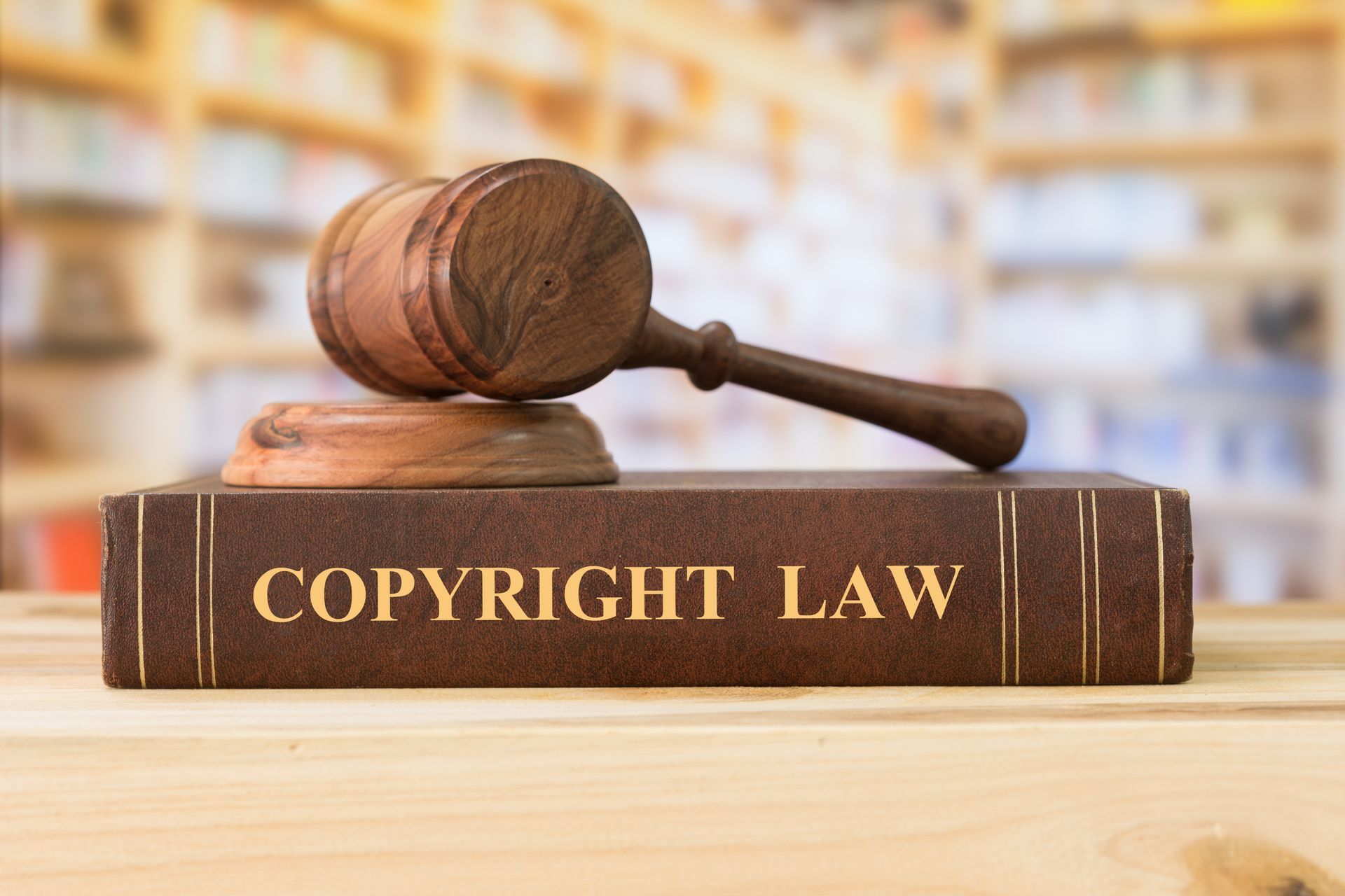 Copyright law books and a judge gavel on desk in the library