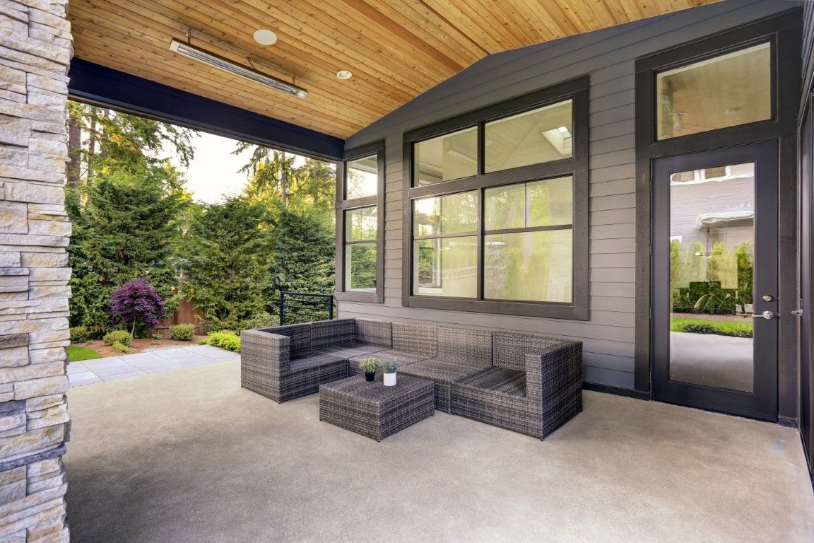 Modern covered outdoor patio with smooth decorative concrete floors.