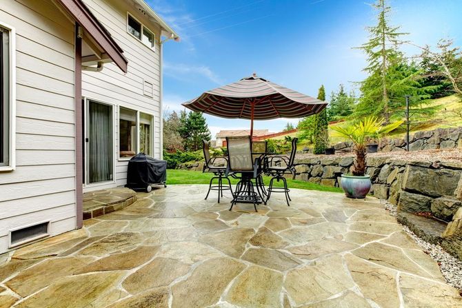 Outdoor dining area on a natural stone look stamped concrete patio.