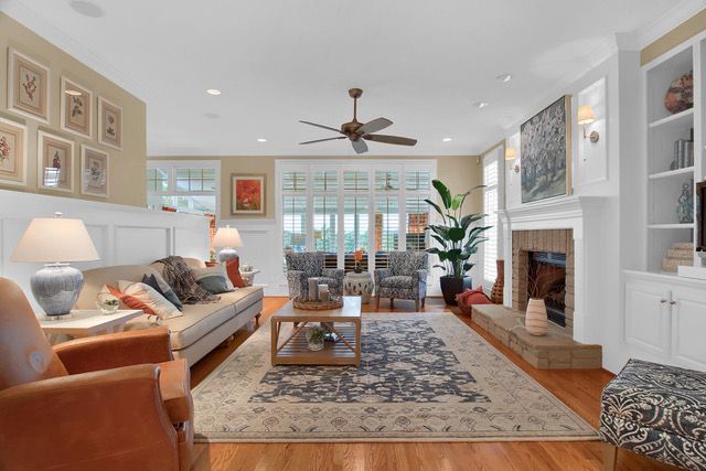 residential design for living room with custom wide fireplace against a floor to ceiling display shelf