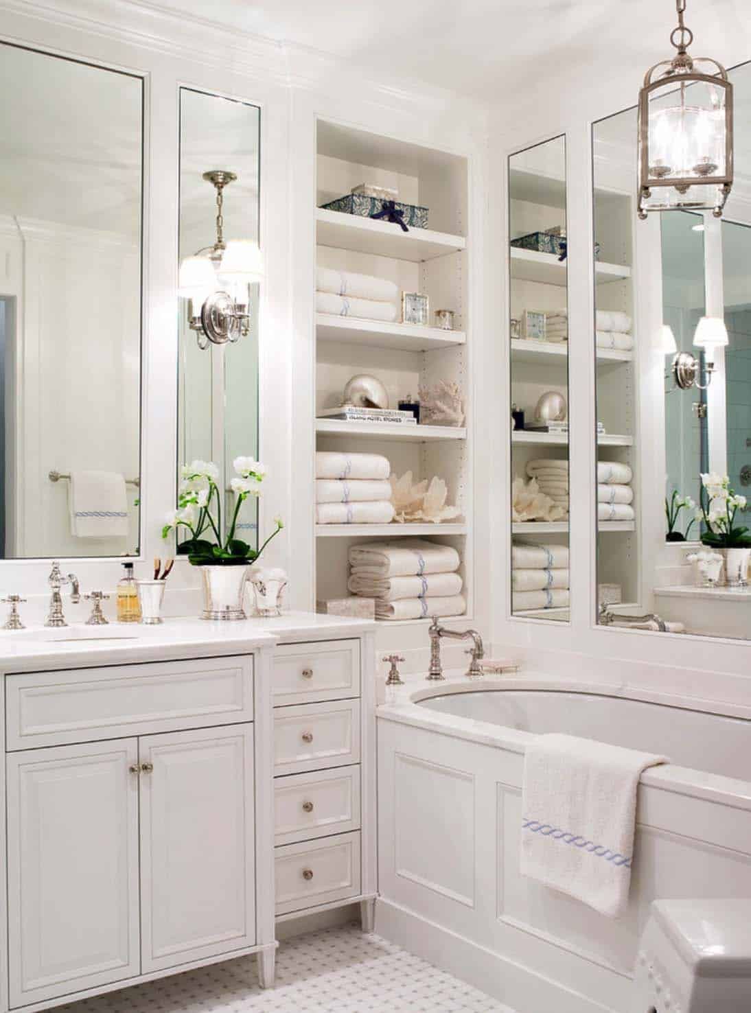 a bathroom with a bathtub , toilet , sink and walk in shower .