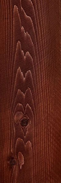 Close-up of reddish-brown wood grain with knots and textured vertical pattern