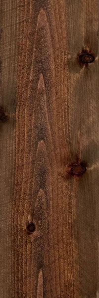 Vertical close-up of dark brown wooden planks with visible knots and grain.