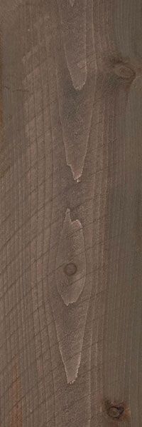 Close-up of a brown wood grain surface with vertical planks and knot details.