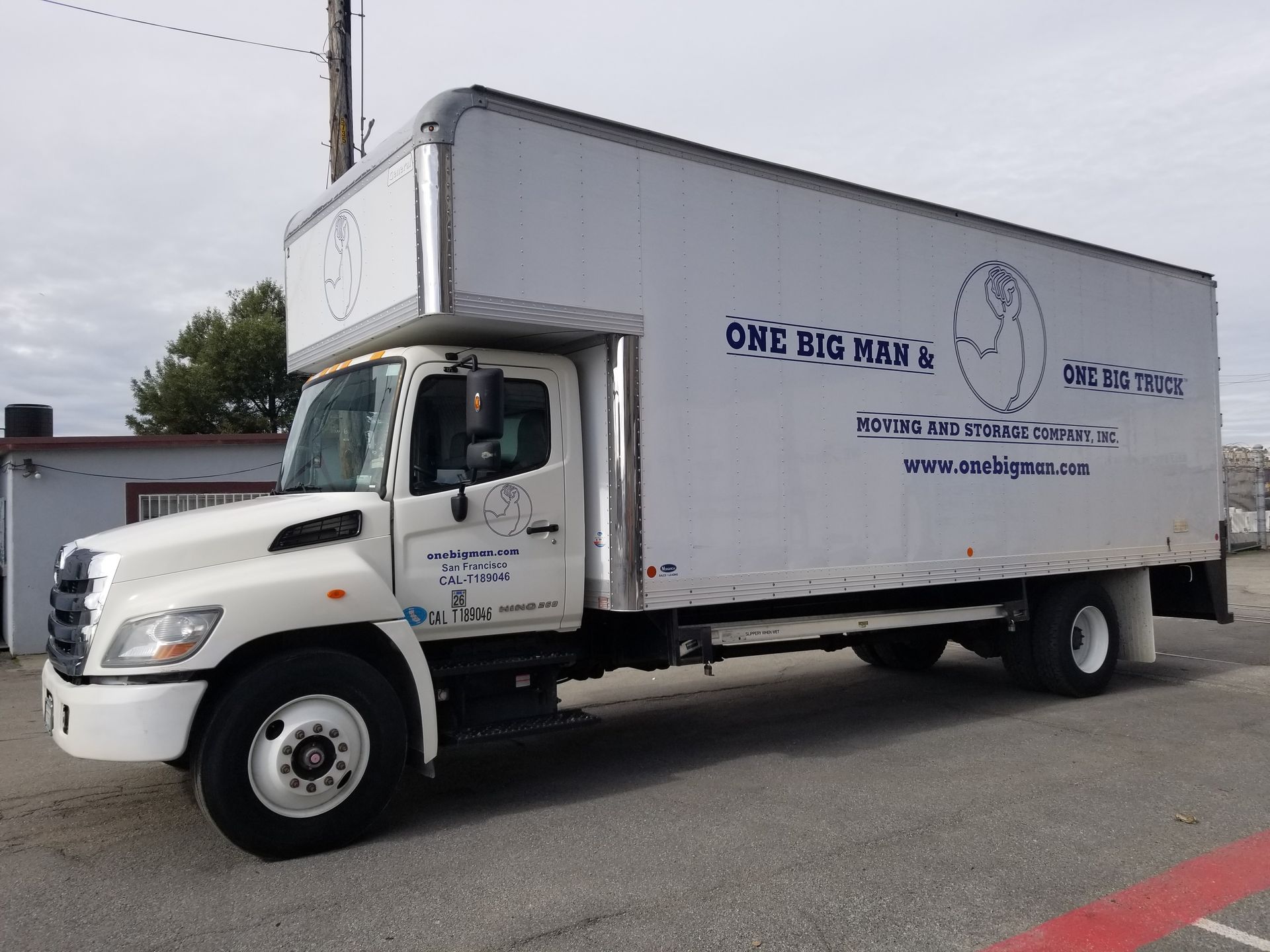 A white box truck is parked on the side of the road