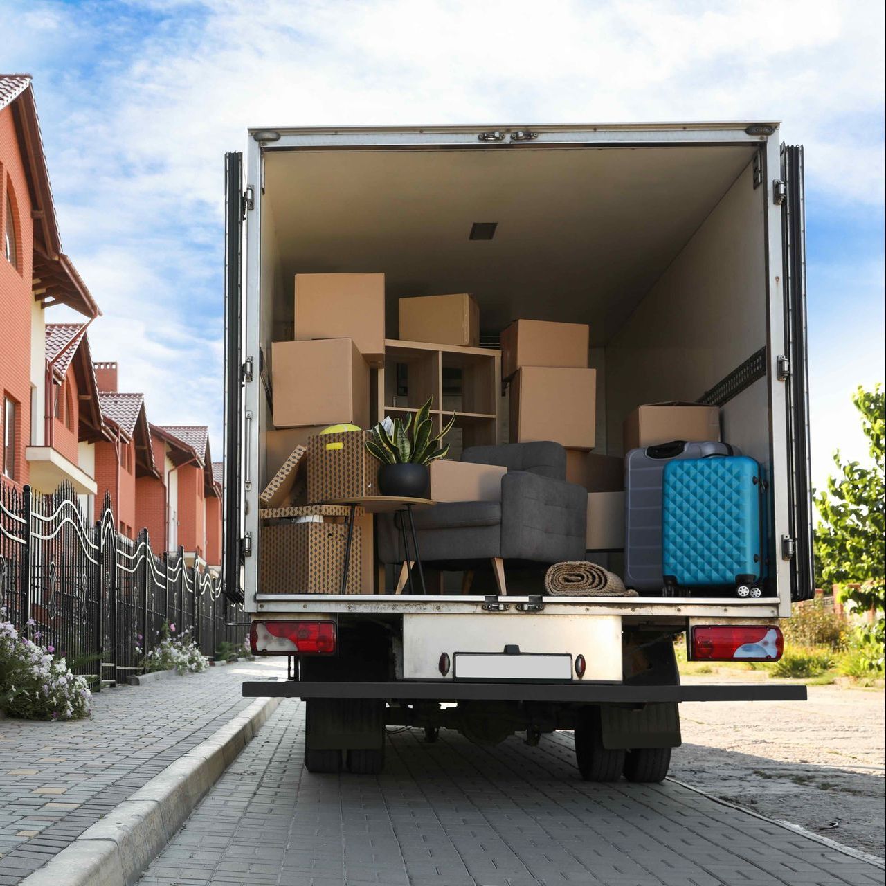A moving truck is filled with boxes and luggage.