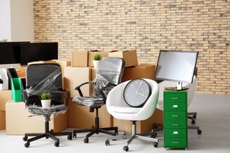 A room filled with office furniture and boxes.