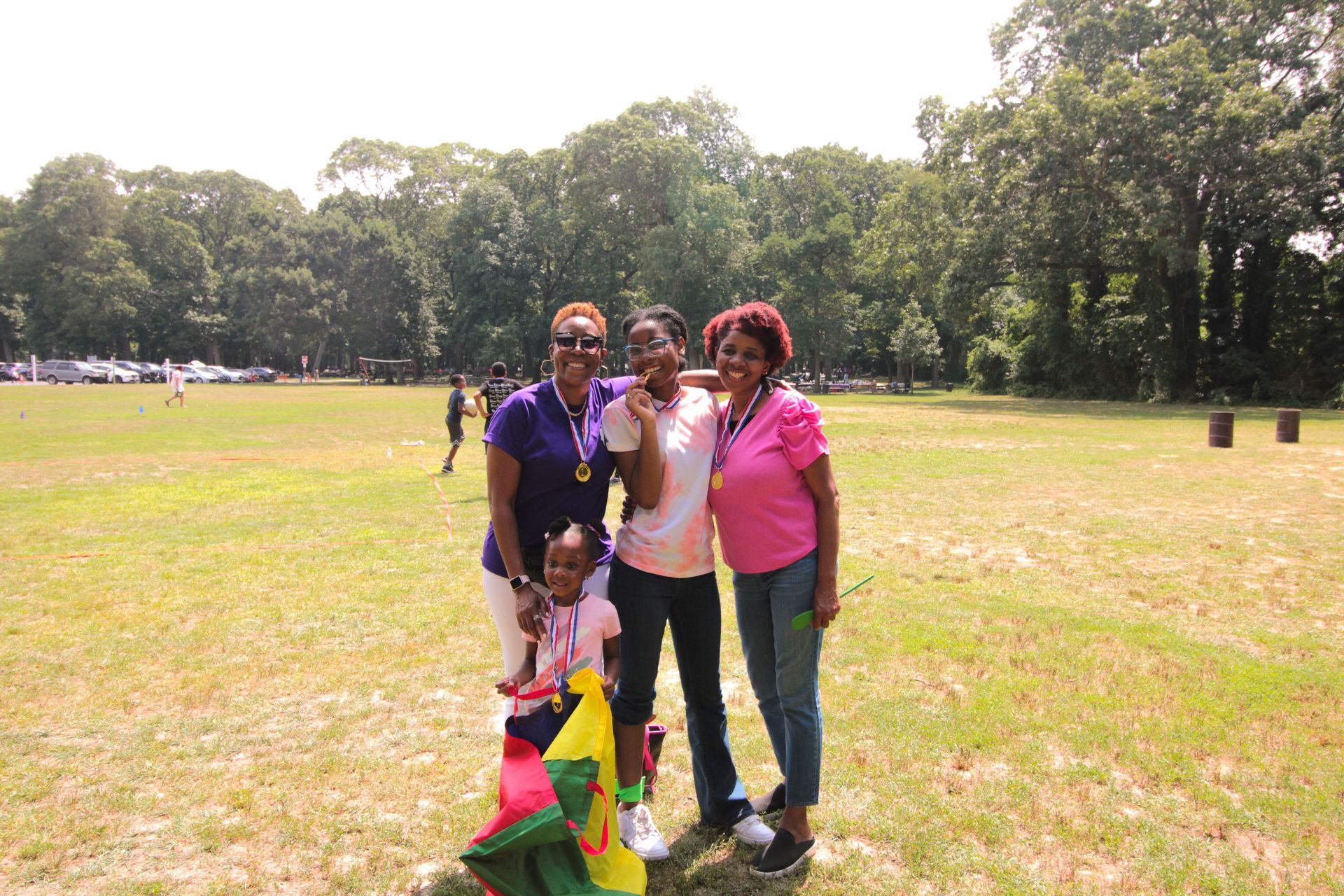 A group of people are posing for a picture in a field.