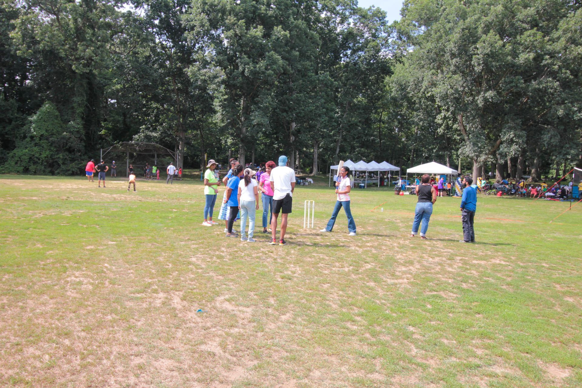 A group of people are standing in a grassy field