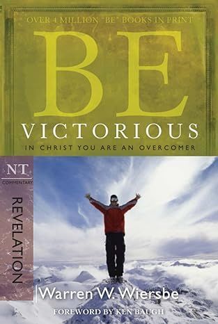 A man is standing on top of a snow covered mountain.