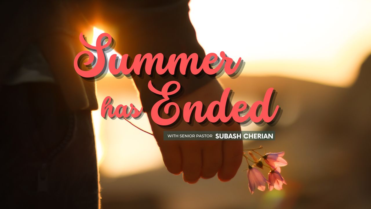 A person holding a flower in front of the words summer has ended