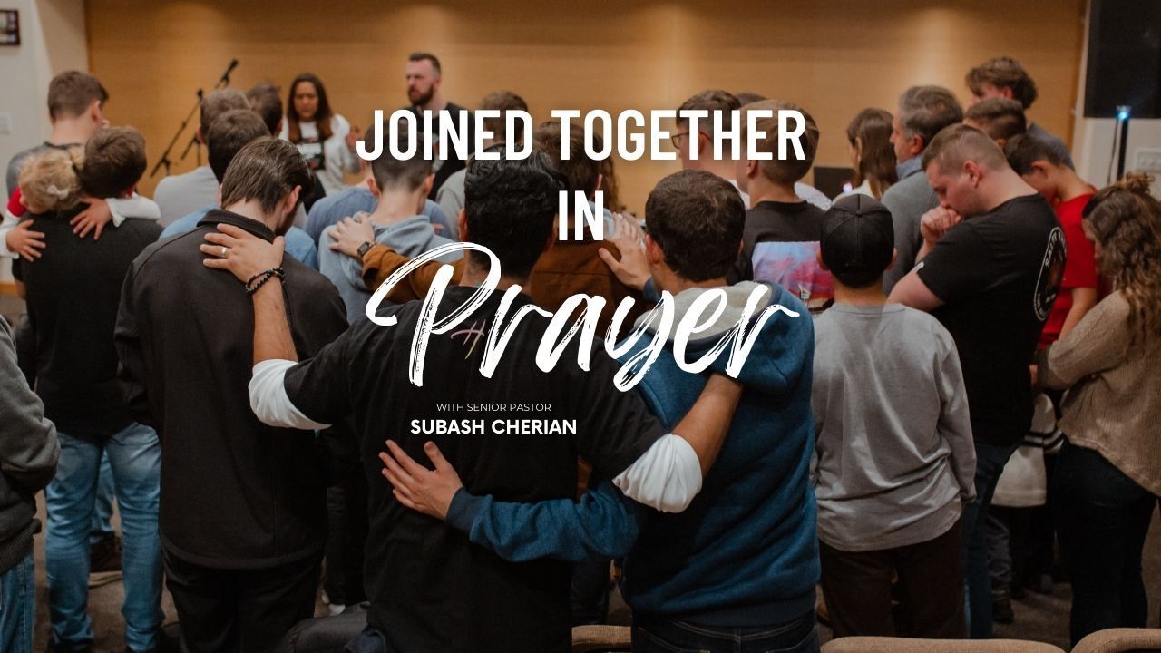 A group of people are standing in a circle with their arms around each other.