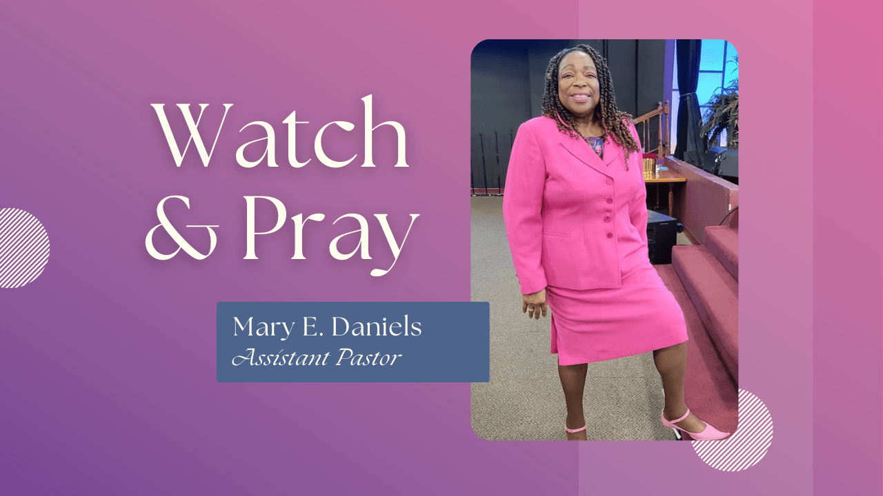 A woman in a pink suit is standing in a church.