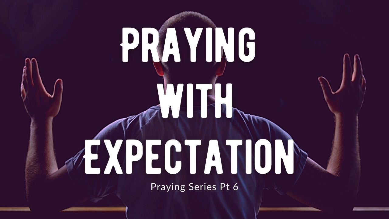 A man is praying with his hands in the air.