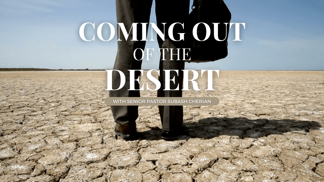 A man in a suit is standing in the desert holding a briefcase.