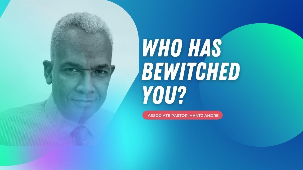 A man in a suit and tie is standing in front of a blue background with the words `` who has bewitched you ''.