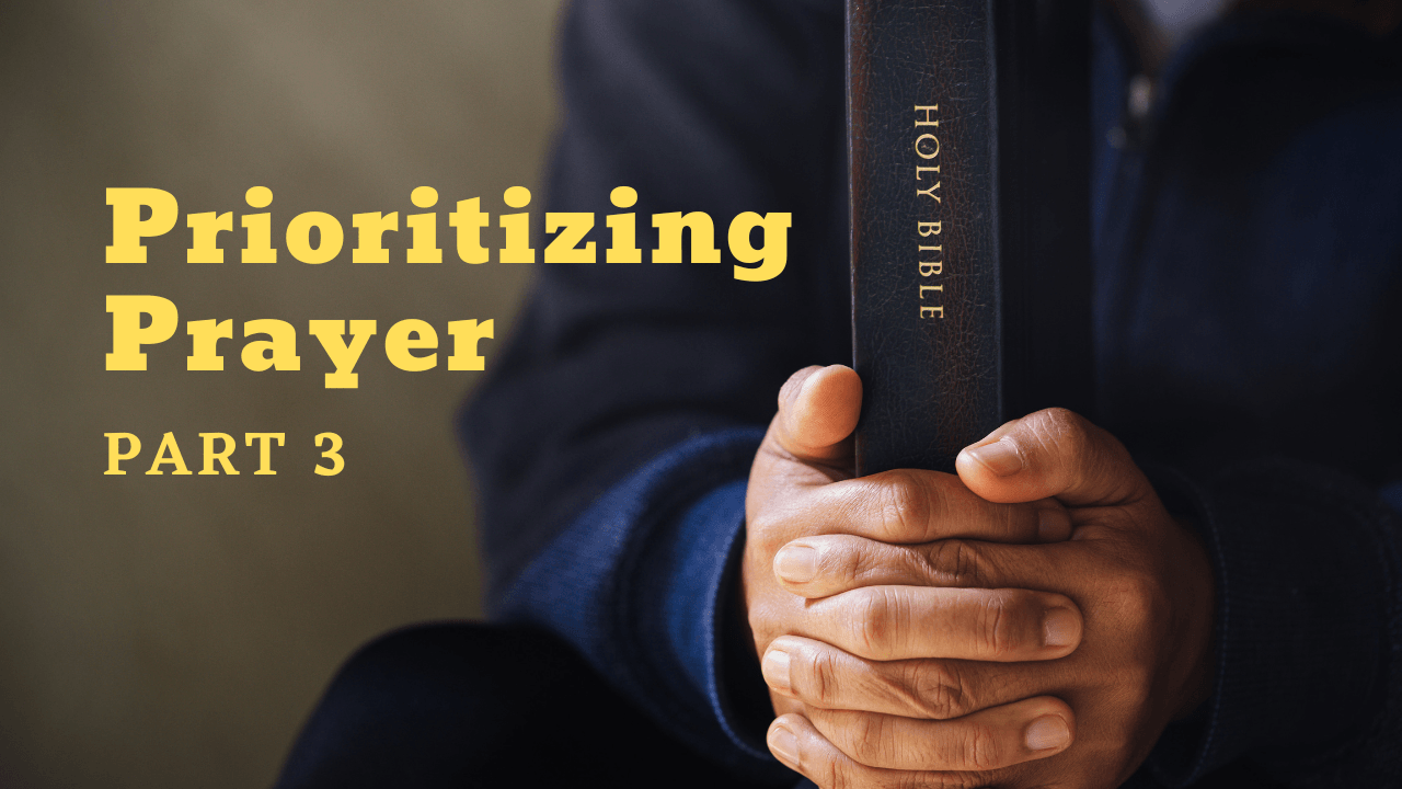 A person is praying while holding a bible in their hands.