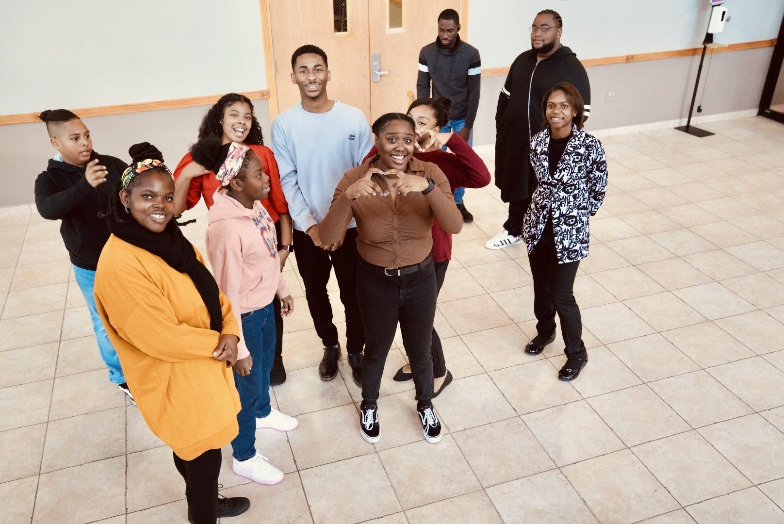 A group of people are posing for a picture in a room.