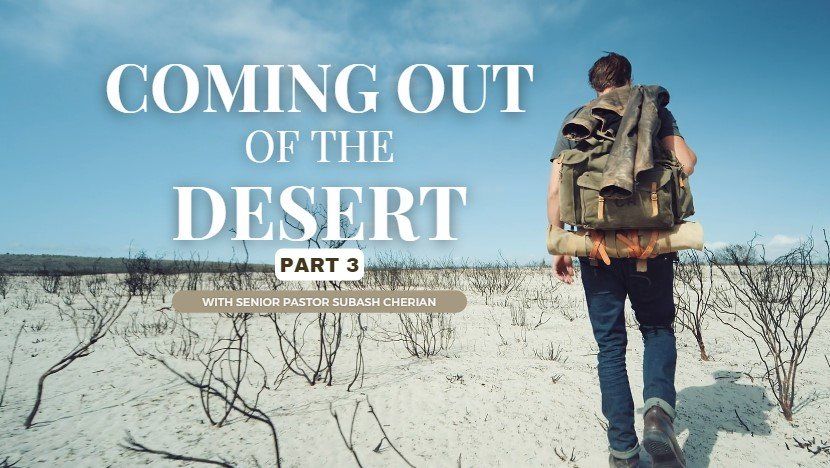 A man with a backpack is walking through the desert.