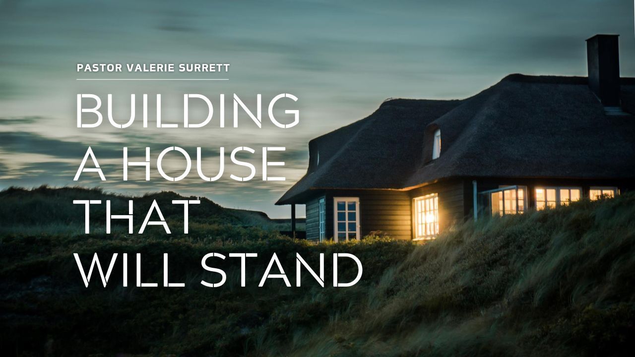 A house is sitting on top of a hill with the words building a house that will stand.