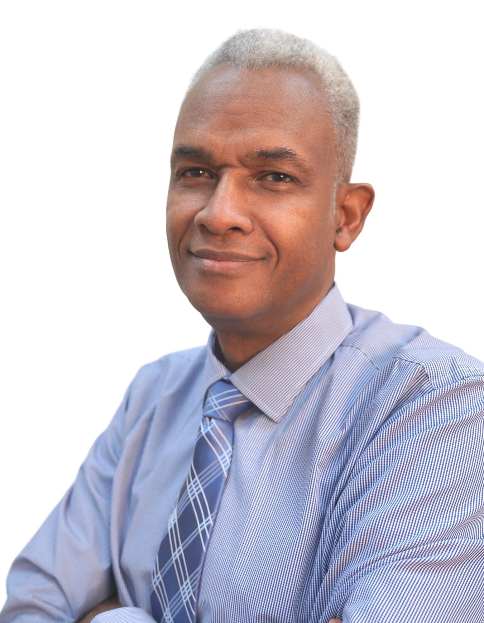 A man in a blue shirt and tie with his arms crossed