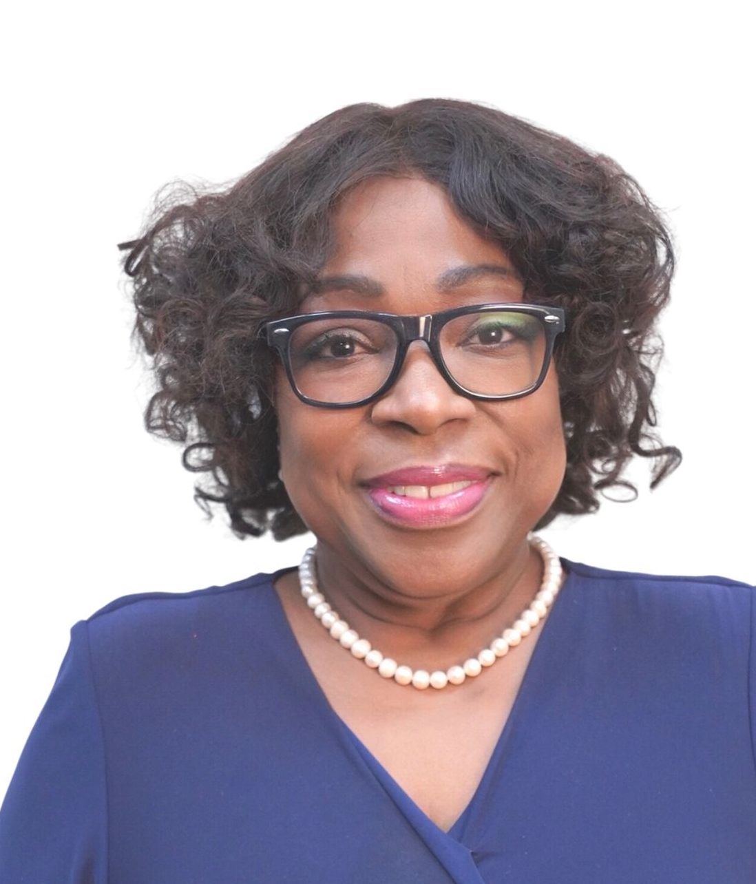 A woman wearing glasses and a pearl necklace