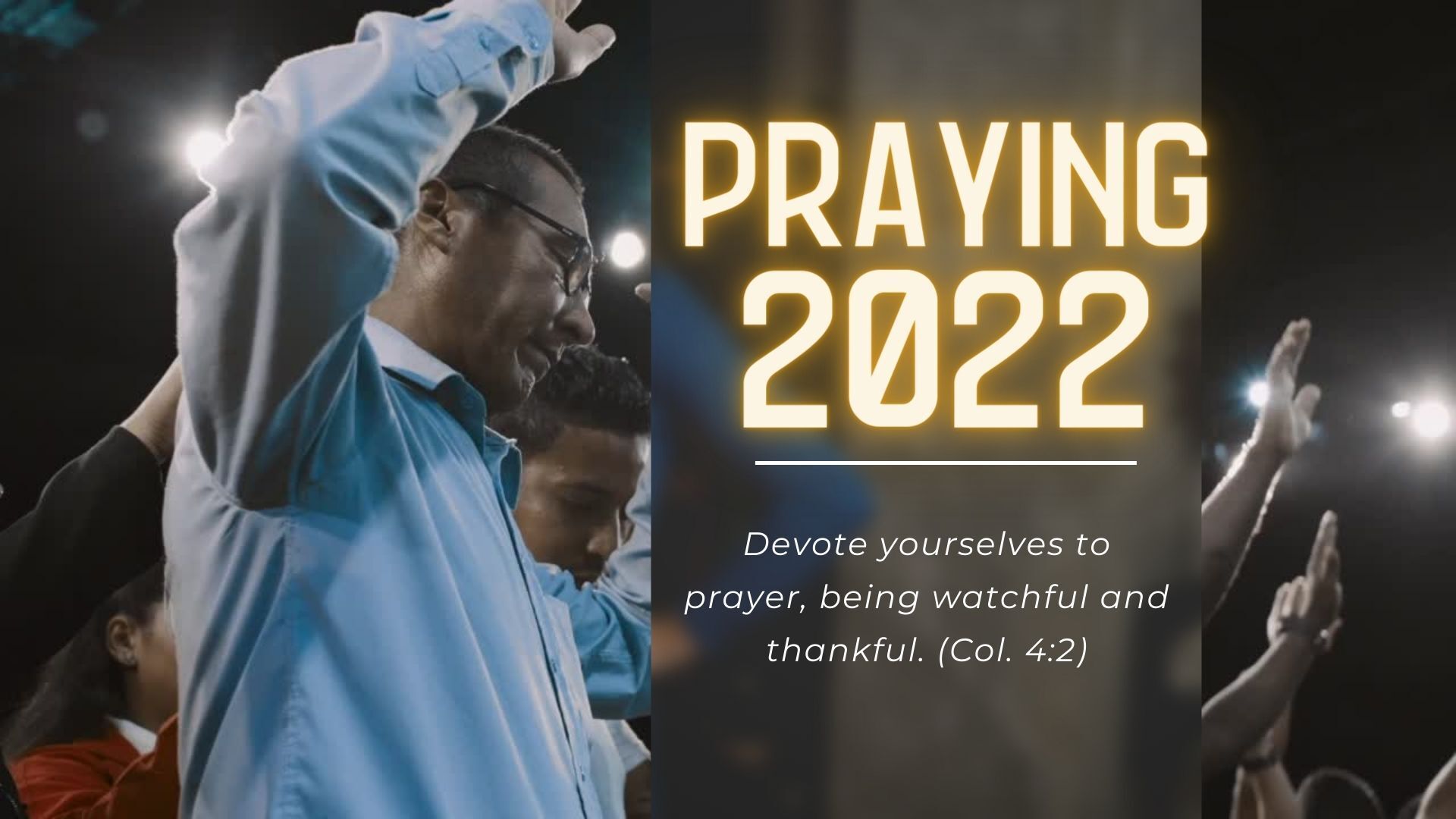 A man is praying in front of a crowd at a church.