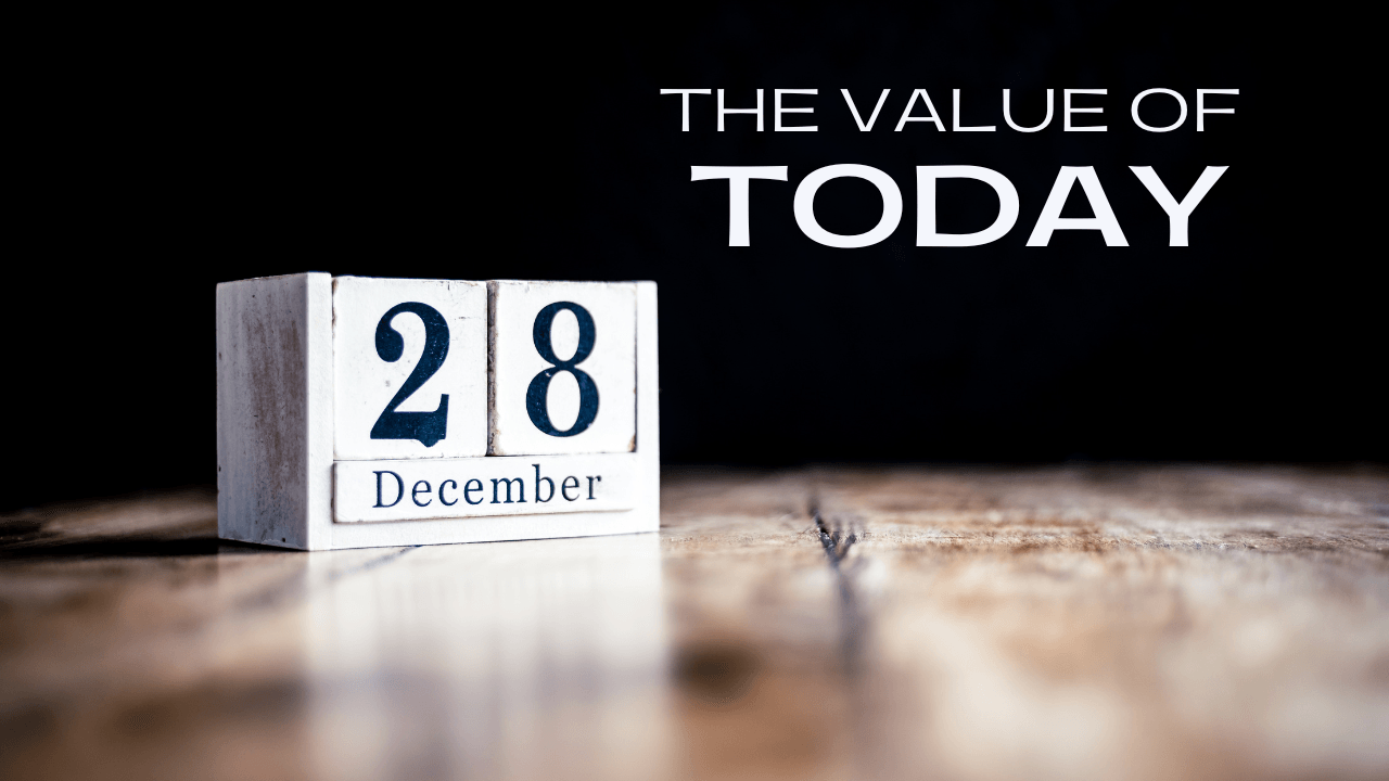 A wooden calendar block with the date of december 28 on a wooden table.