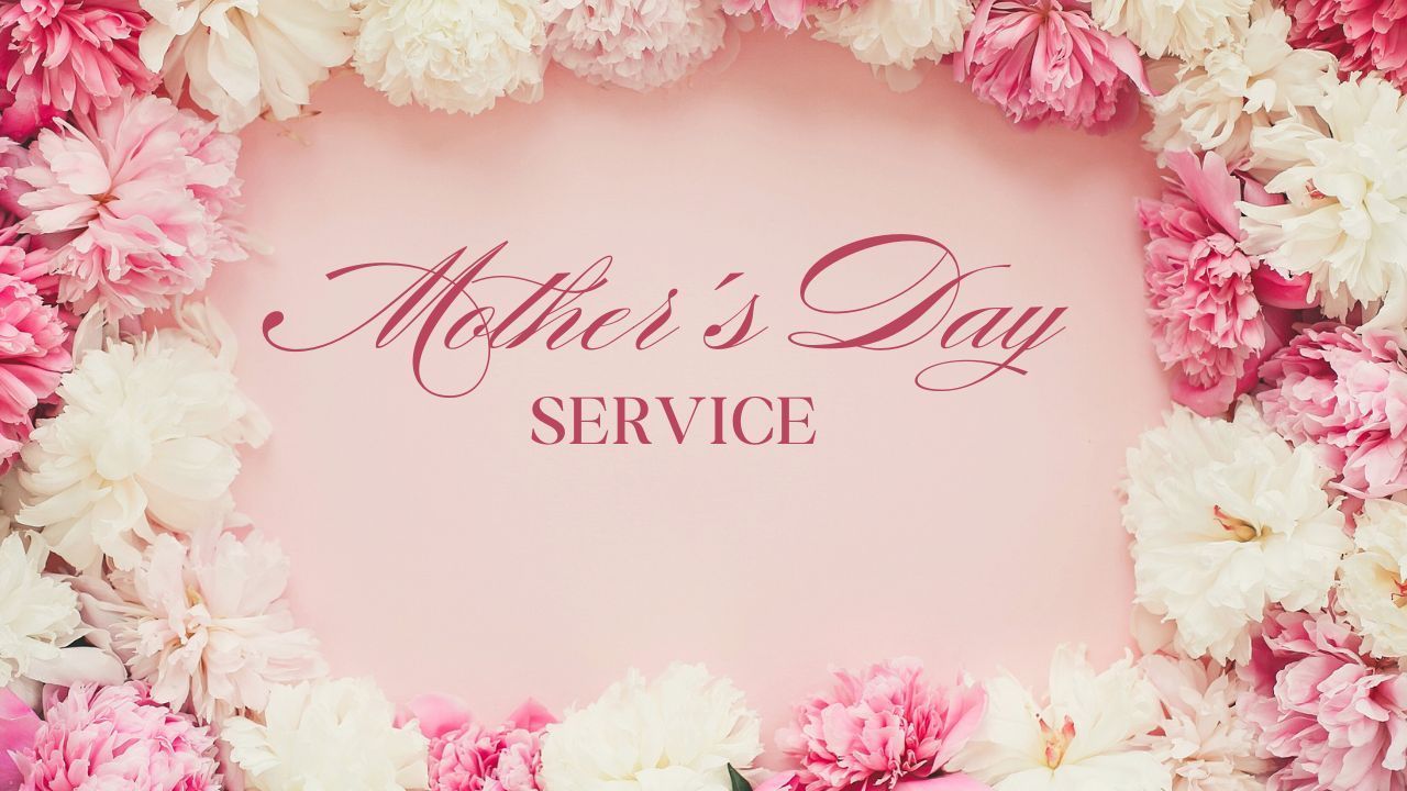 A heart made of pink and white flowers on a pink background for mother 's day service.