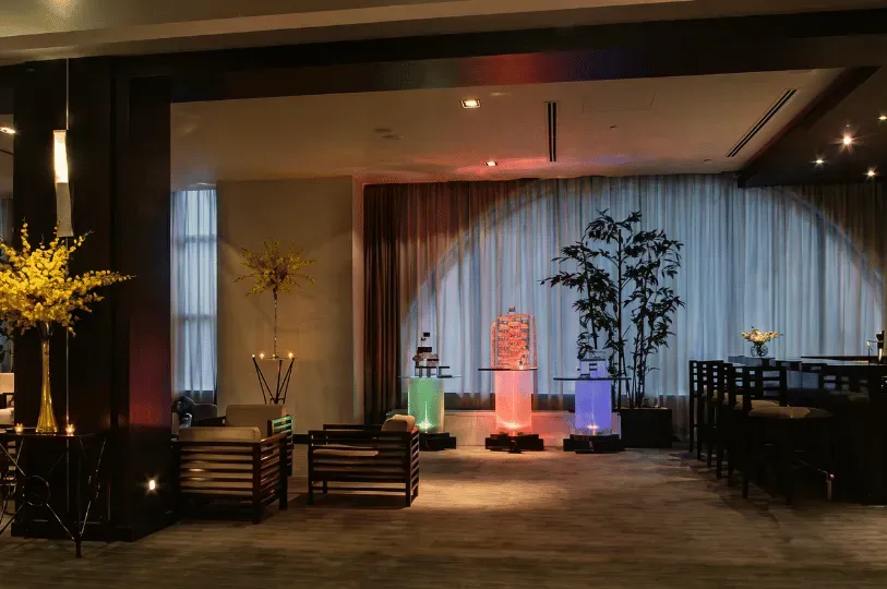 A tranquil, dimly lit lounge or lobby devoid of people, capturing a quiet moment of stillness. The s