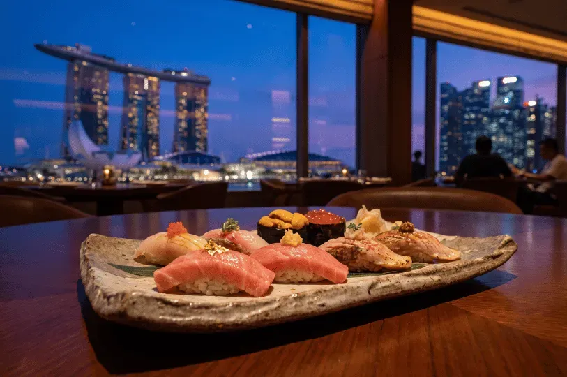 An exquisite platter of premium nigiri sushi, including glistening tuna garnished with gold leaf, cr