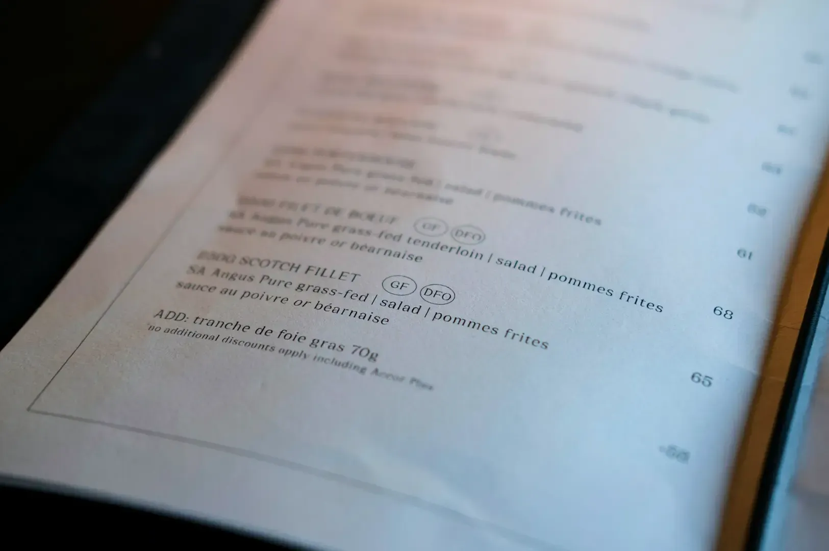 Close up shot of a menu page with some items visible along with their prices.