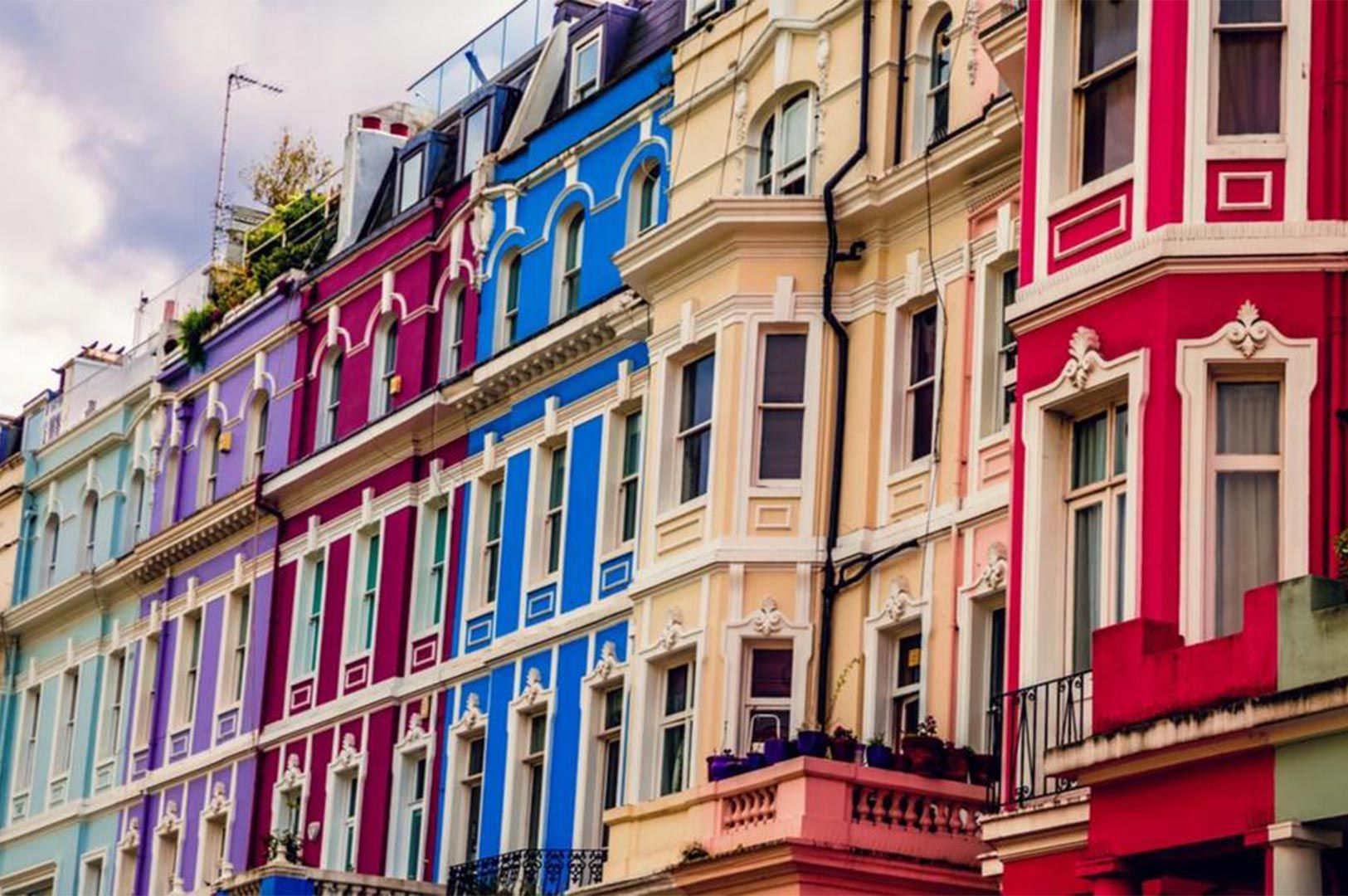 Close-up view of the famous brightly colored Victorian terraced houses in Notting Hill, London.