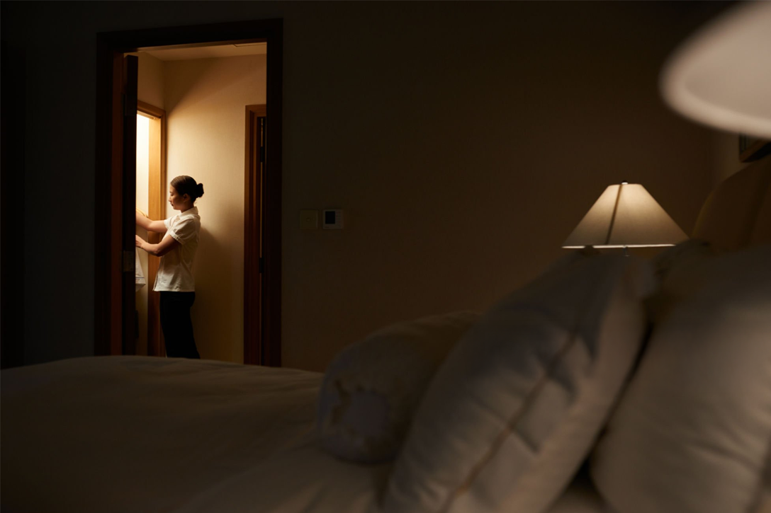 The Midnight Concierge : Housekeeping team performing overnight cleaning in an empty  hotel room.