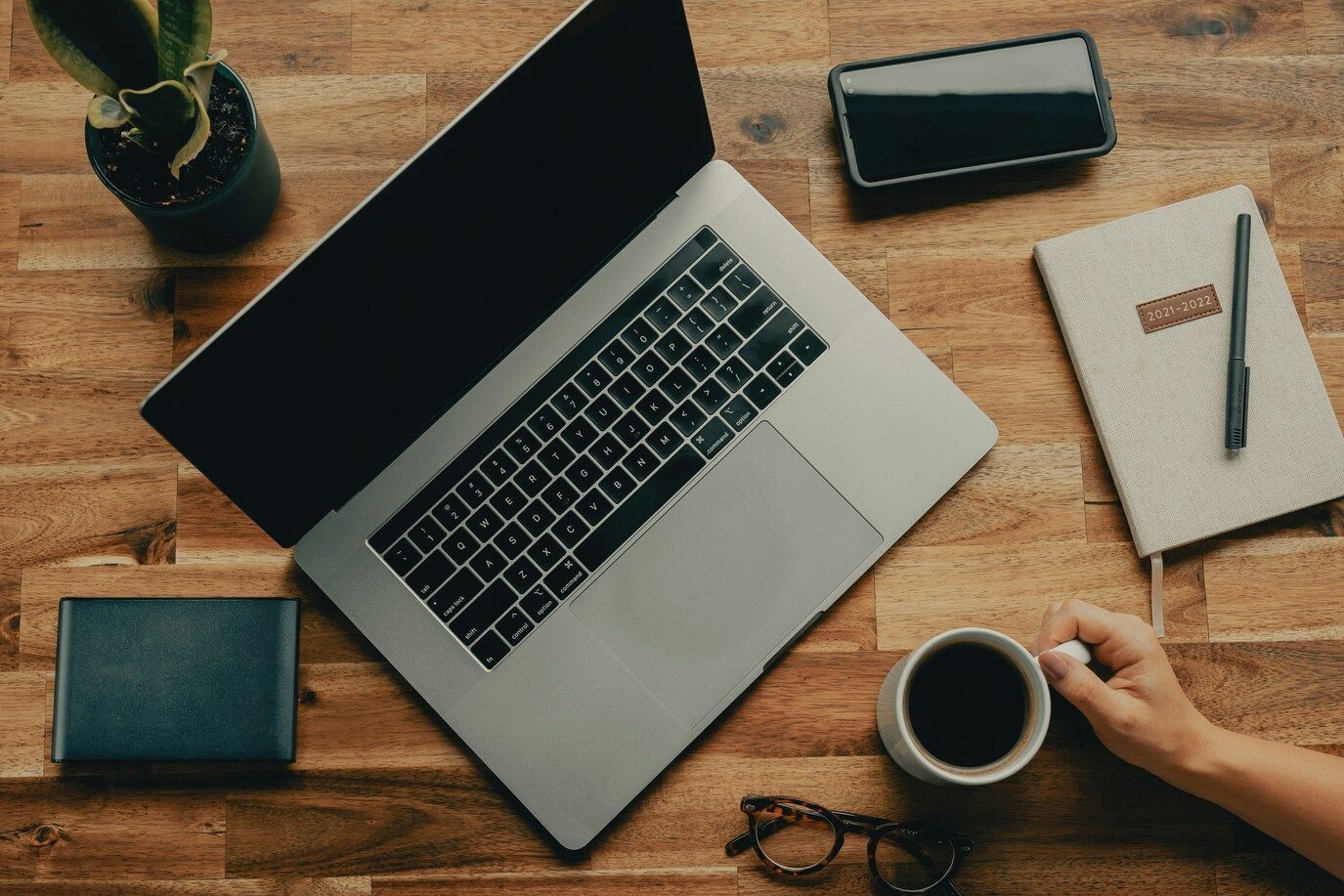 Travelling Assistant : Laptop open at a café table, blending work and travel lifestyle.
