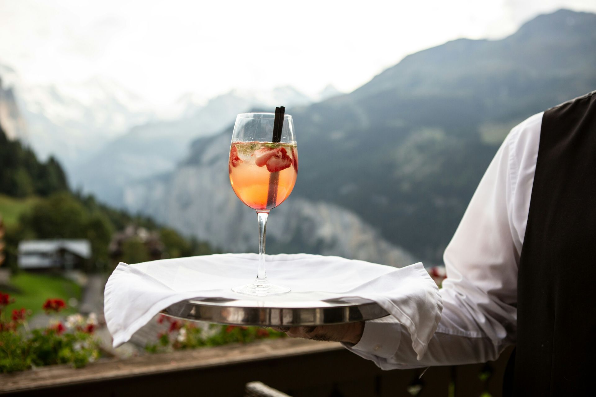 5 Ultra-Luxury Hotels: Butler presenting a tray of cocktails with precision and grace