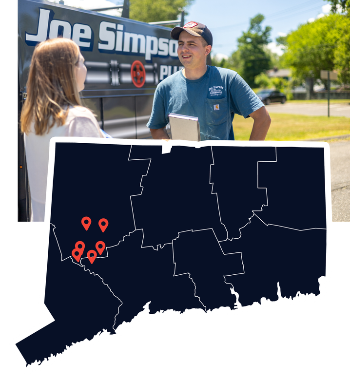 A man and a woman are talking in front of a joe simpson truck