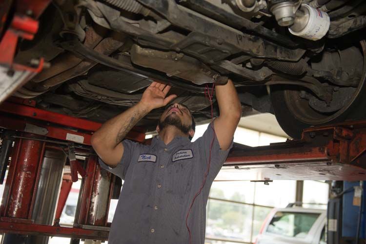 Mechanic Performing Undercarriage Inspection | Protime Automotive