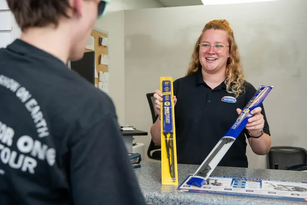 Customer Receiving Friendly Service At Front Desk | Protime Automotive