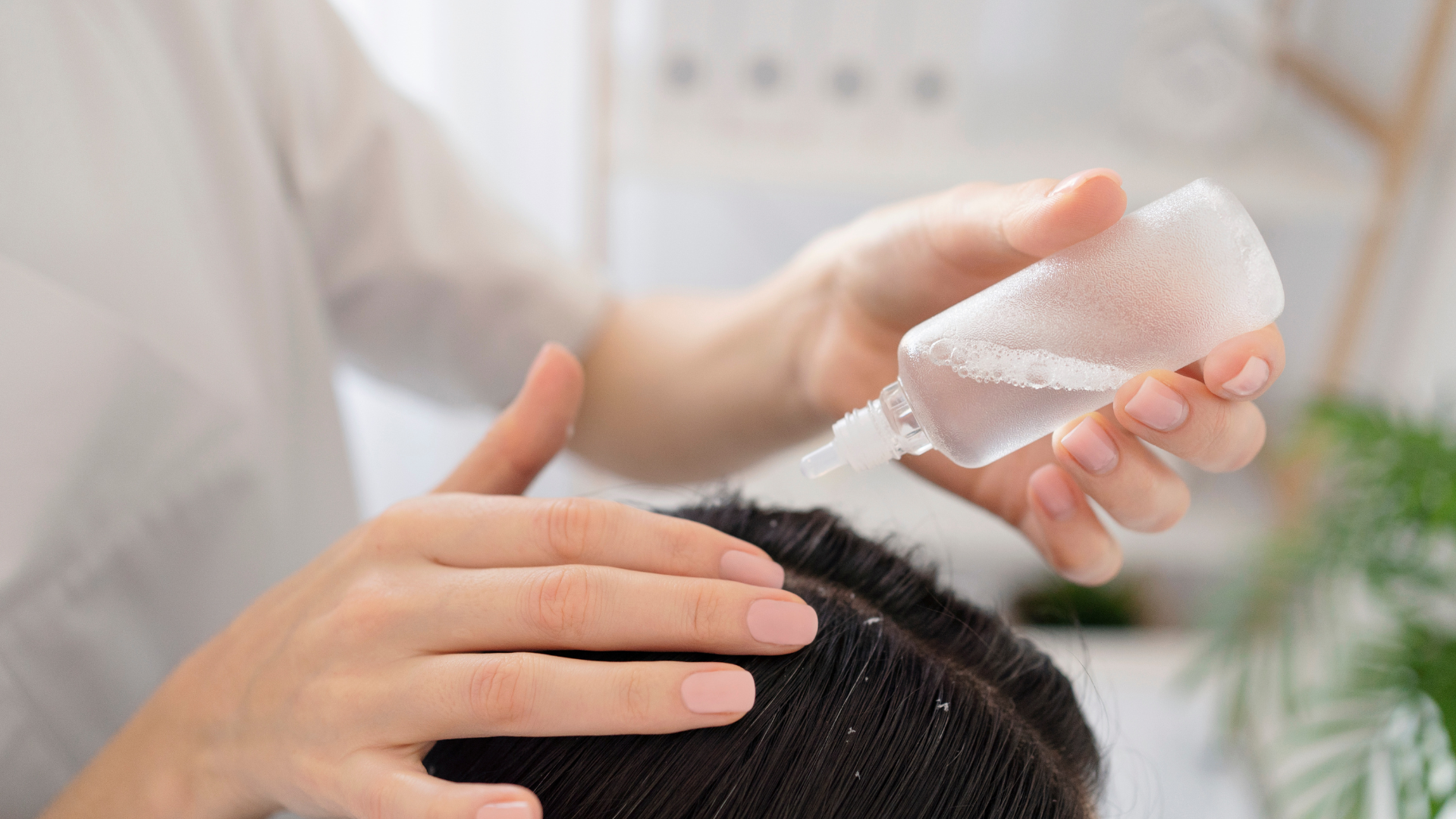 A woman is applying lotion to a man 's hair.