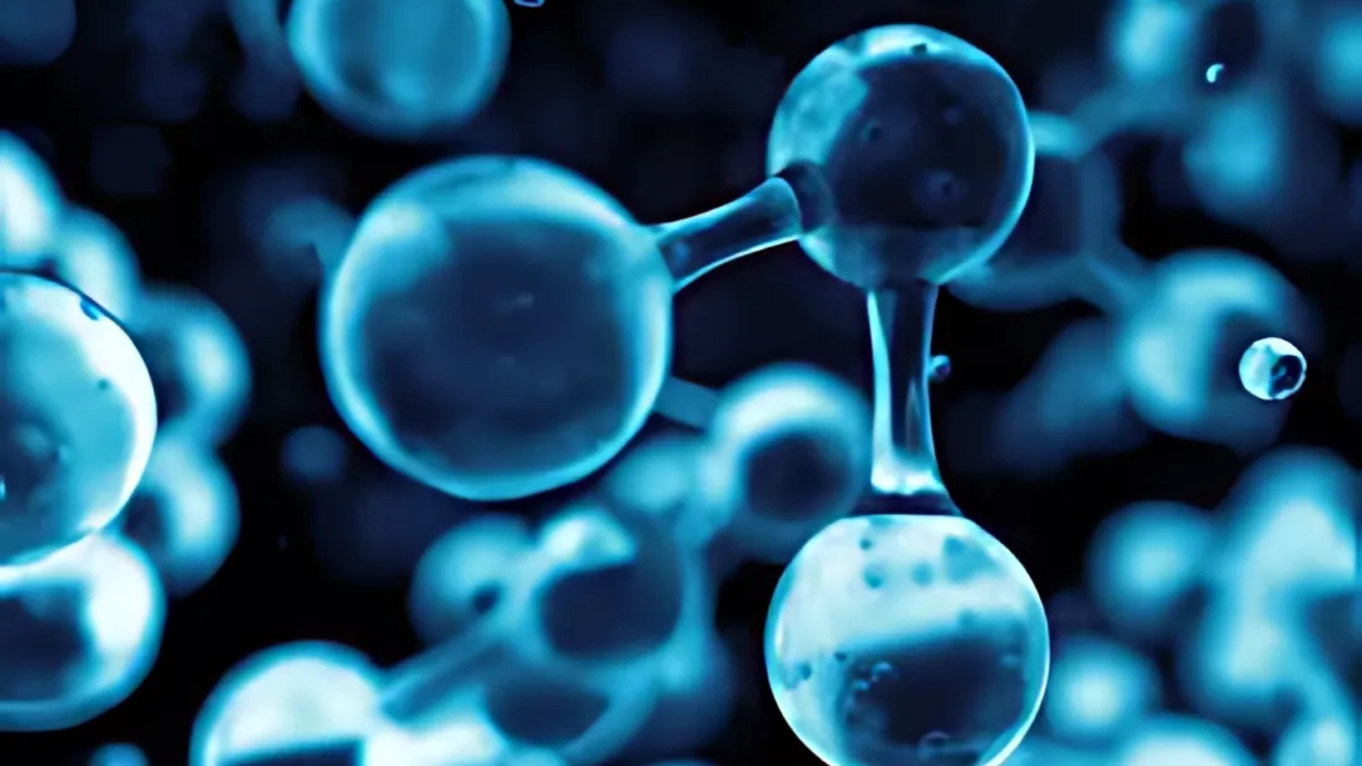 A close up of a blue molecule on a black background.