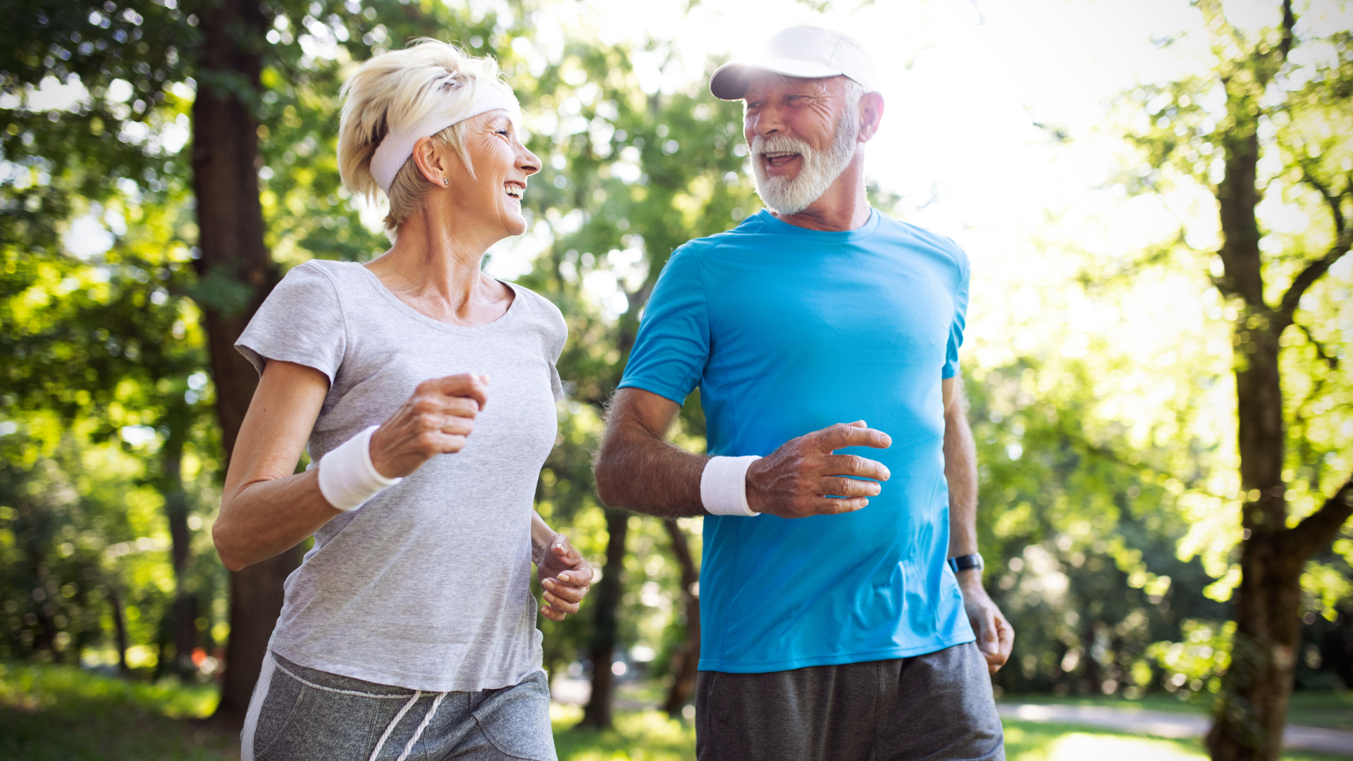 A man and a woman are jogging in a park.