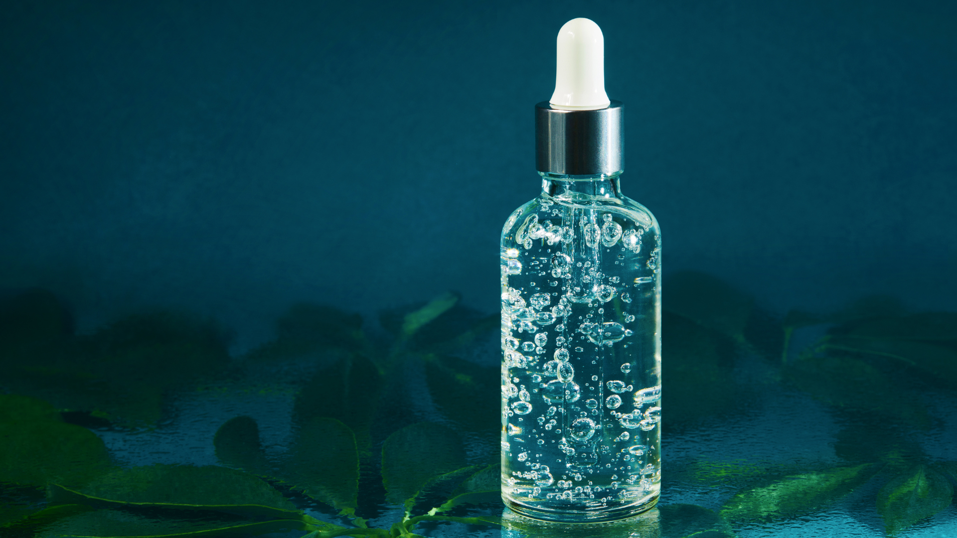 A bottle of liquid with a dropper on top of it.