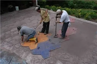 Downers Grove Concrete Contractors installing stamped concrete using pattern mats on a residential patio