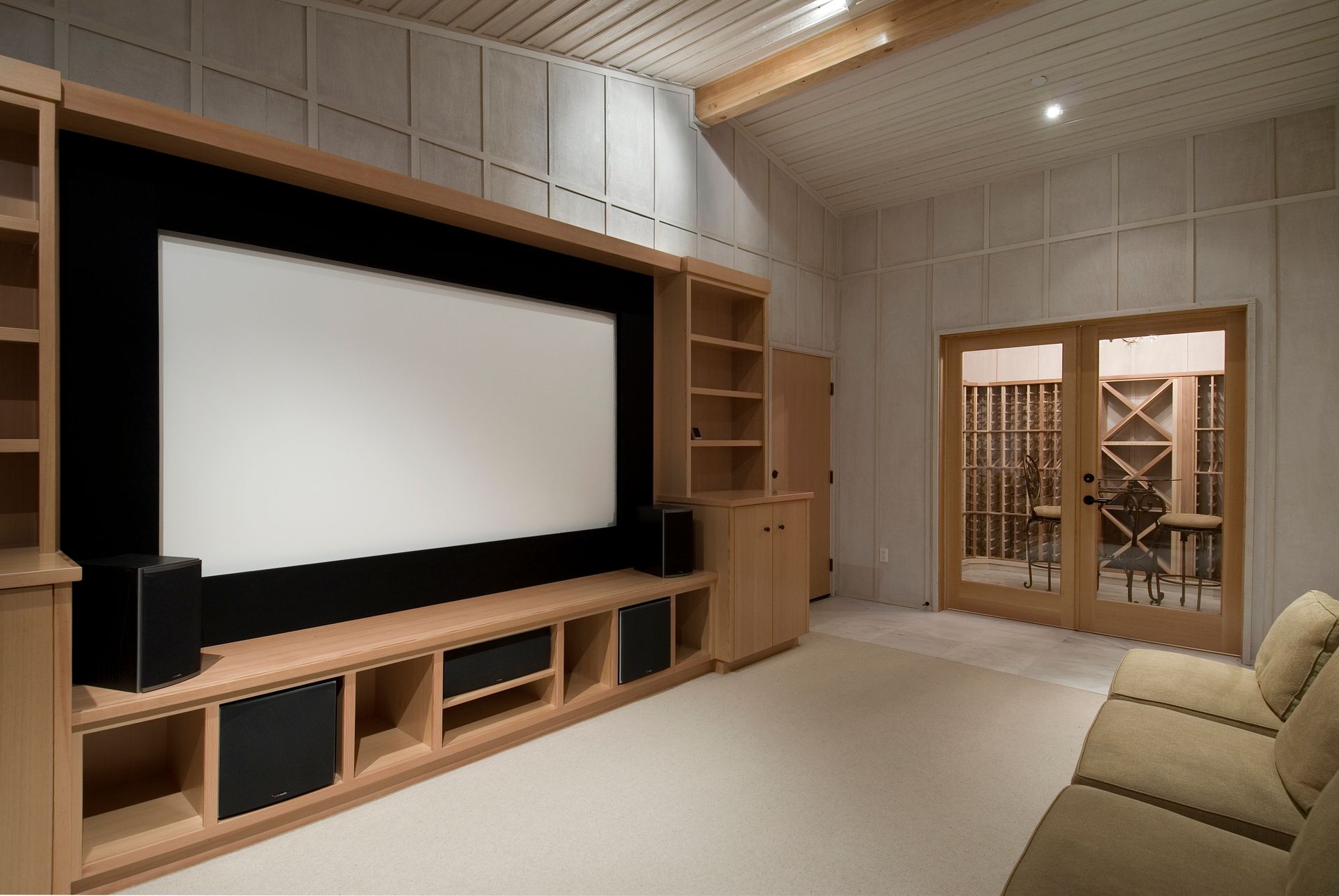 AV equipment setup in a room with a sofa and a projector screen, representing AV equipment rentals.