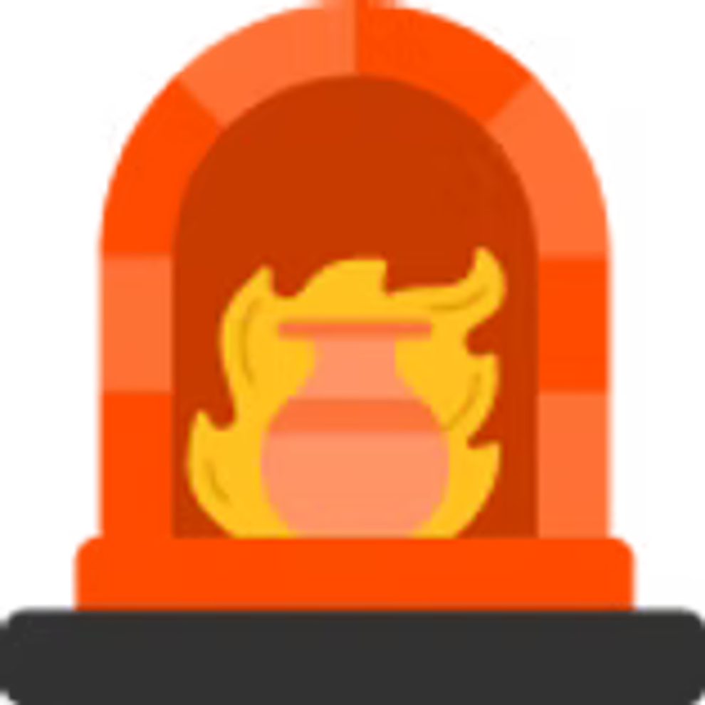 Ceramic kiln with a pot inside burning in orange flames.